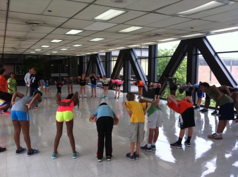 Members of the Academic Center Cross Country team stretch during a summer practice