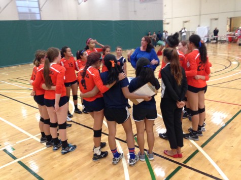 The girls volleyball team huddles during their game vs Payton on Aug 28. 
