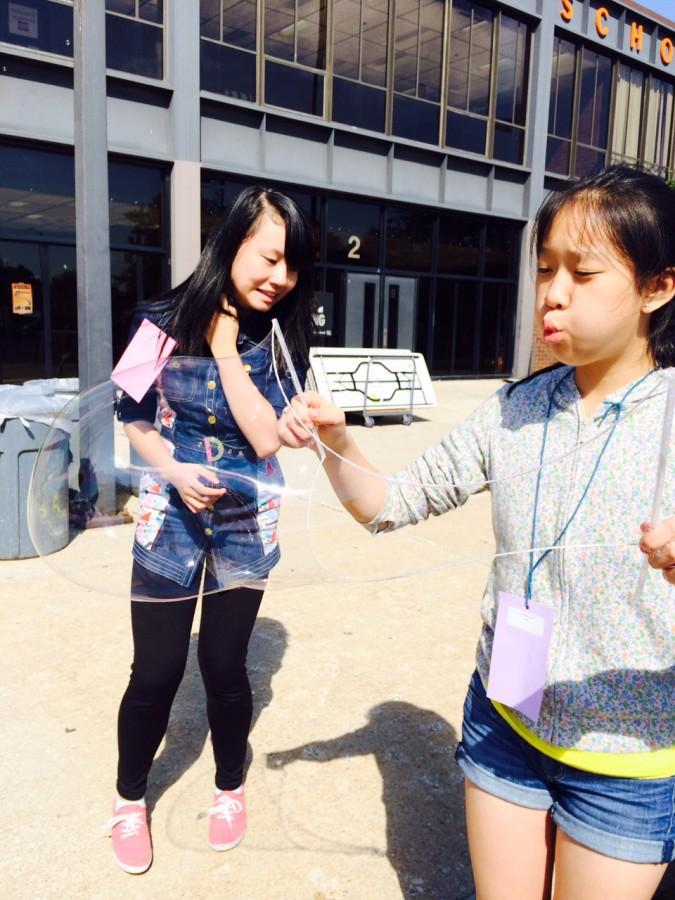 Crystal Lin 19 blows bubbles at the Academic Center Walkathon Fundraiser