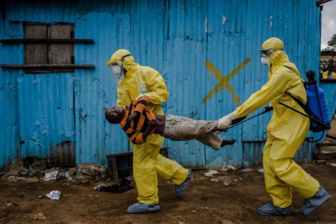 Medical staff carry James Dorbor, 8, suspected of having Ebola, into a treatment facility in Monrovia, Liberia, Sept. 5, 2014.  