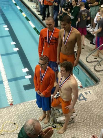 Mossimo Chavez '15 Tony Tremmel '15 Julian Escaba '15 and Zac Stensland '15 posing after finishing seventh in the medley relay
