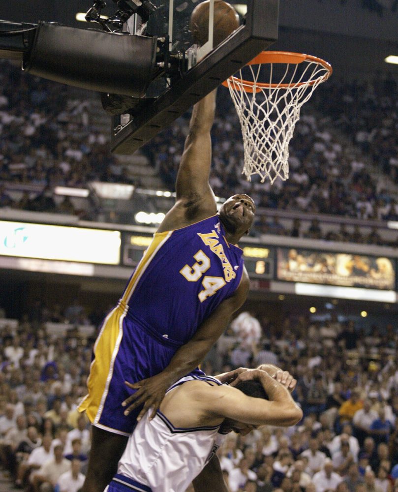 SACRAMENTO, CA - MAY 28:  Center Shaquille ONeal #34 of the Los Angeles Lakers dunks over center Vlade Divac #21 of the Sacramento Kings in Game five of the Western Conference Finals during the 2002 NBA Playoffs at Arco Arena in Sacramento, California on May 28, 2002.  The Kings won 92-91.   NOTE TO USER: User expressly acknowledges and agrees that, by downloading and/or using this Photograph, User is consenting to the terms and conditions of the Getty Images License Agreement.  (Photo by Jed Jacobsohn/Getty Images)