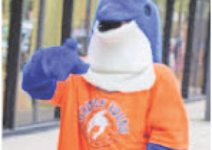Flip the Dolphin, Whitney Young Mascot, extends a fin invitingly.